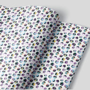 a sheet of wrapping paper with a white background and jungle floral polka dots 