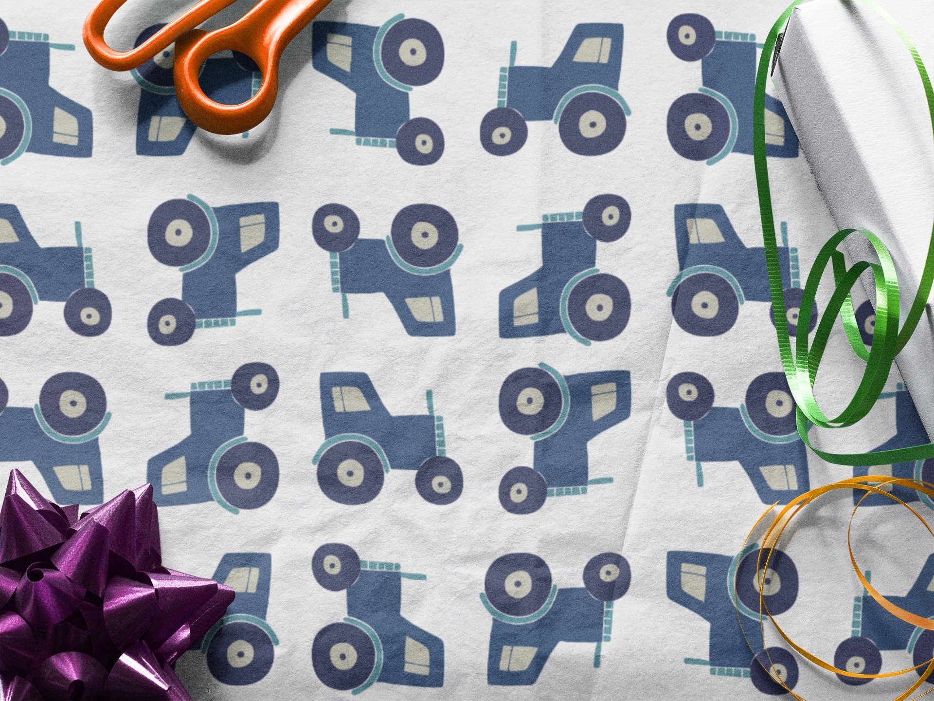 Wrapping Paper with Blue Farm Tractors, scissors and ribbon sitting on top