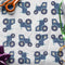 Wrapping Paper with Blue Farm Tractors, scissors and ribbon sitting on top