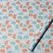 A sheet of wrapping paper with turquoise, orange and outlined elephants 