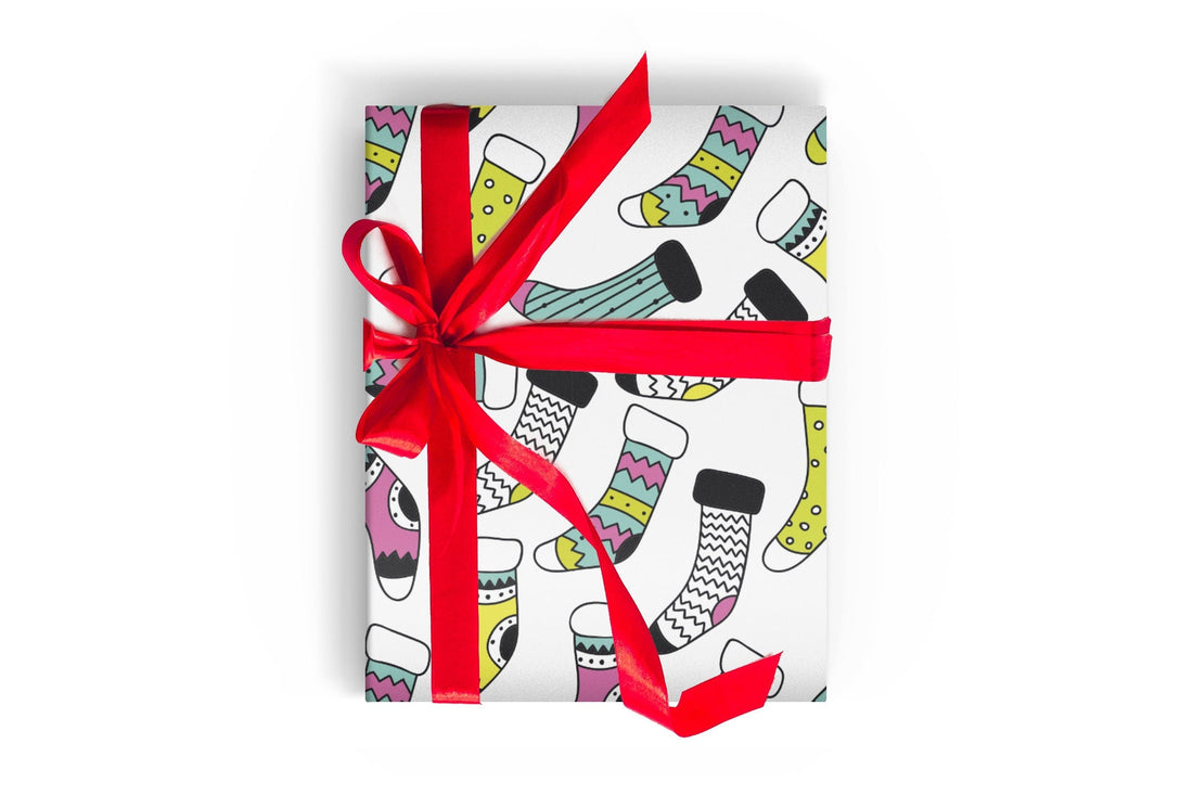Christmas Wrapping paper with bright colored socks or bright colored christmas stockings with a red ribbon and bow tied around it 
