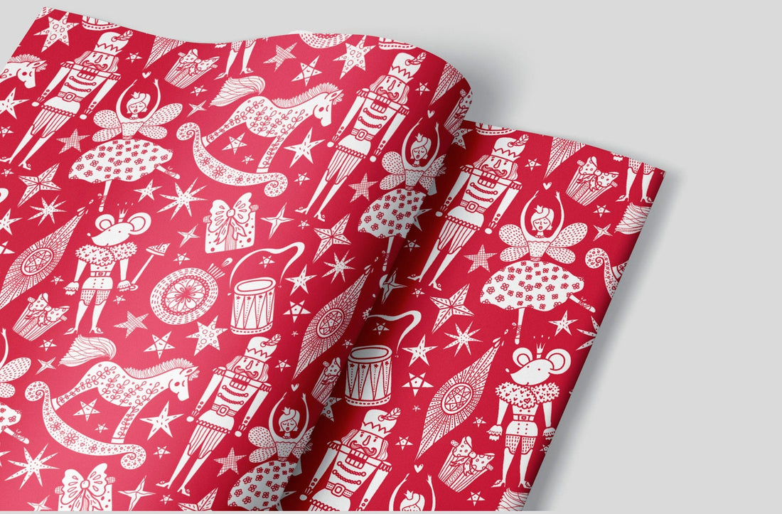 Red christmas wrapping paper with white night of the nutcracker characters