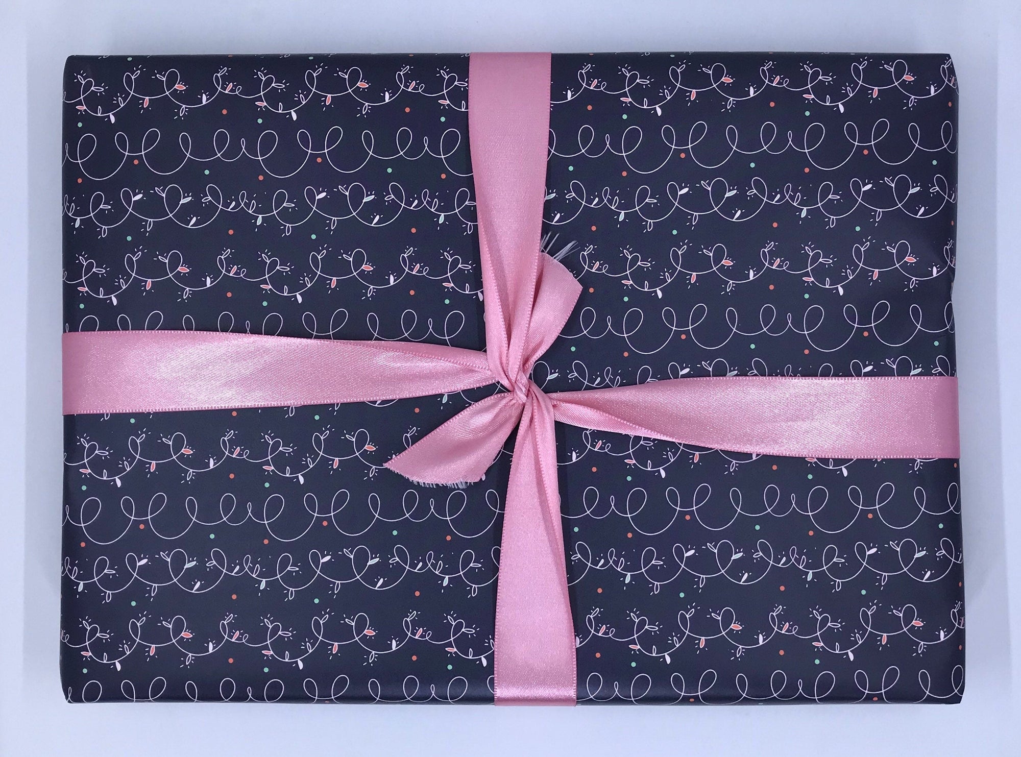 Navy wrapping paper with pink christmas lights